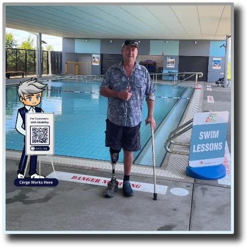 A person with a disability standing before a swimming pool.