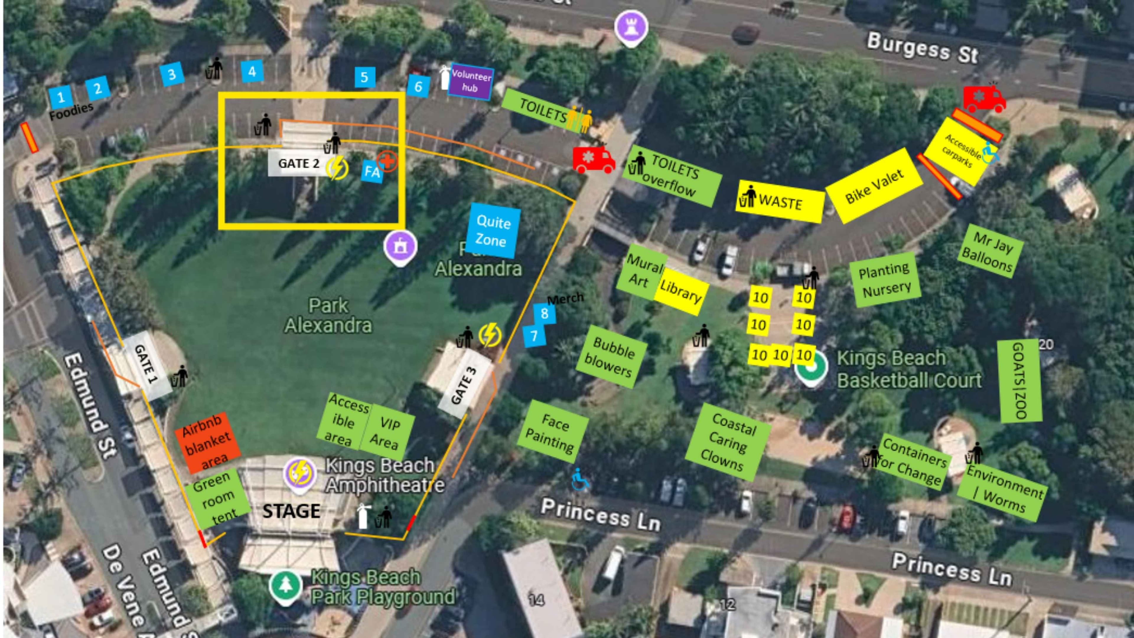 Aerial view of Kings Beach area. Left side shows a curved road with a tall yellow boundary marking and a red Airbnb tent near a stage area labeled “Kings Beach Amphitheatre.” Pathways run along Edmund Street and Gate 1. Foreground features a large green park lawn and a stage building; right side shows a cluster of green and yellow signs for amenities near a basketball court and adjacent streets, with trees and parked cars beyond. Background includes Princess Lane and surrounding buildings.