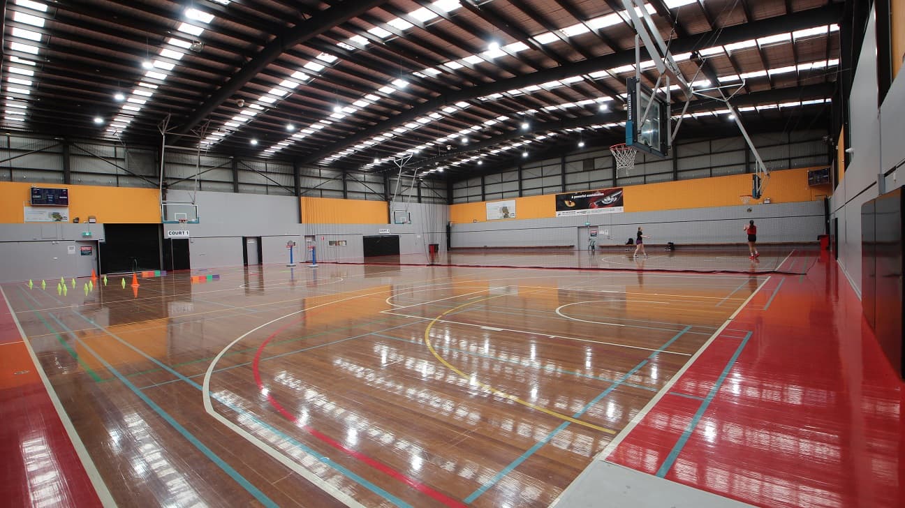 Gymnasium is divided into two courts. The first court is labeled as “Court 1” while the 2nd court is labeled “Court 2”. Separating the two courts is a net.