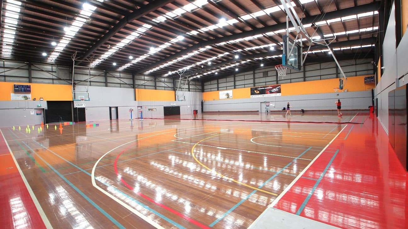 Gymnasium is divided into two courts. The first court is labeled as “Court 1” while the 2nd court is labeled “Court 2”. Separating the two courts is a net.