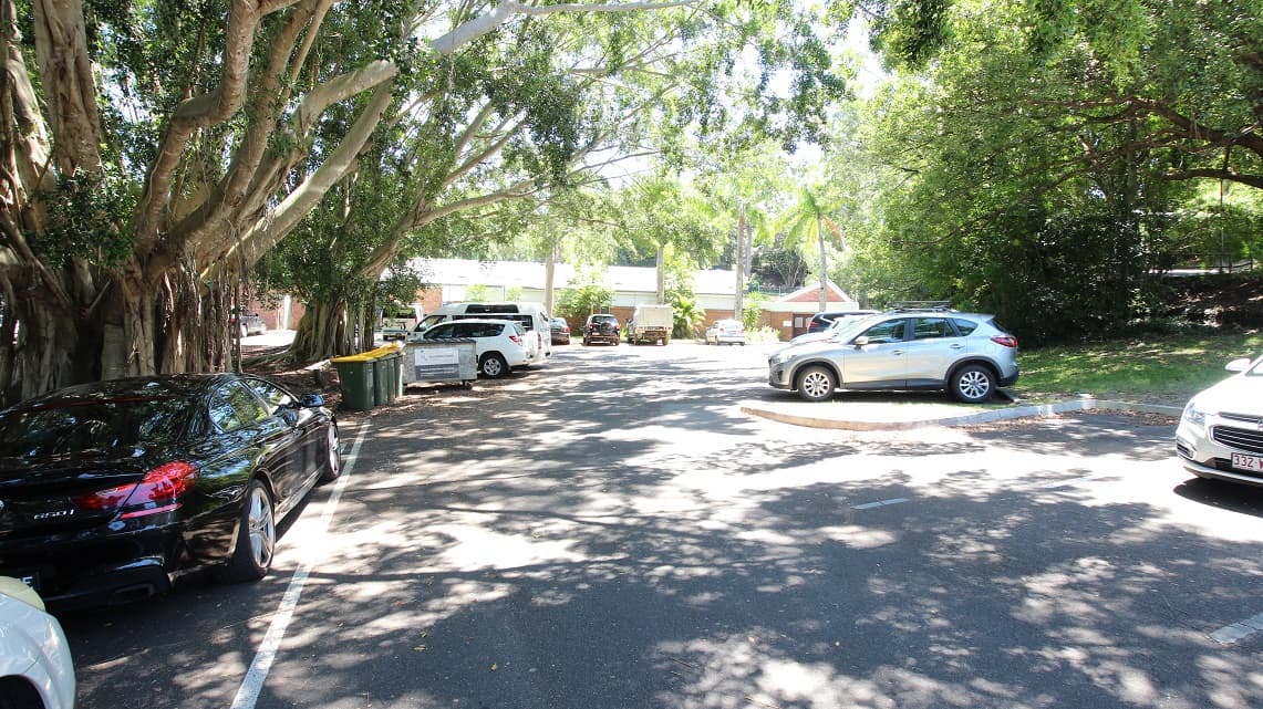 Set back further from the preceding images to showcase the winding car park around the Nambour Aquatic Centre. It is also shown the significant shading across the carpark due to the dense foliage of the surrounding green trees.