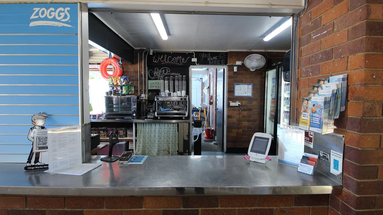 The reception counter at the Nambour Aquatic Centre is approximately 1200mm high and a stainless steel finish. Within the reception area is a coffee machine and basic menu food items.