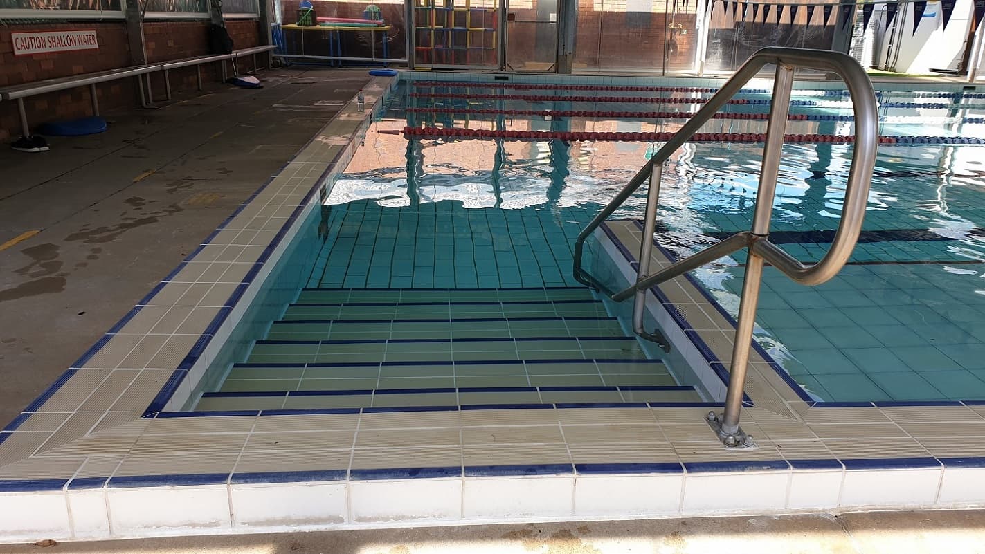 Accessible entry to the 25m pool includes stainless steel handrail over approximately 6 steps into the pool.