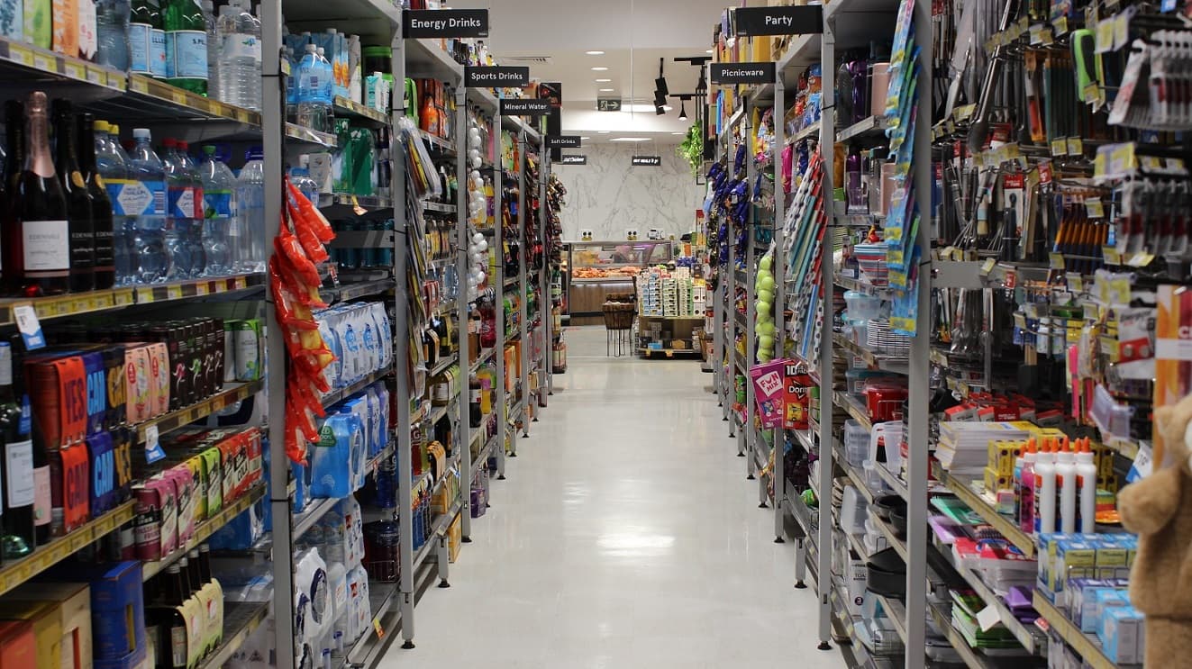 At the left side of this grocery section, there are a variety of drinks such as wine, soda, energy drinks, sports drinks and bottled mineral water. The opposite display rack has the items needed in the party like picnicwares, party hats and decorations. The aisle of this section seems pleasant and clean because of the white and tidy floor.