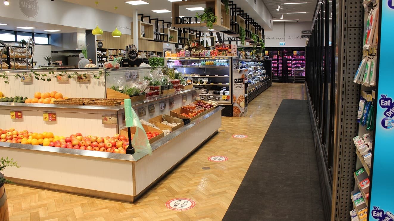 When you first enter White's IGA Peregian Beach, you'll notice to your right a selection of fresh flower bouquets, fruits, and vegetables. On the left is the bakery and pantry section with lots of pieces of bread and other baking needs.