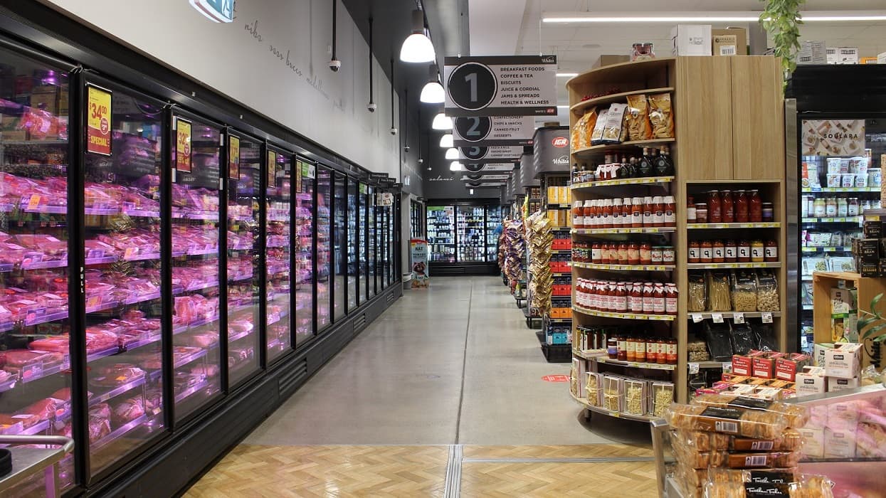 An image showing the meat section to the left. At the ceilings are hanging boards that have a summary of food categories from 1-6 for each rack. Hanging board no. 1 is for breakfast foods, coffee & tea, biscuits, juice, jams & spreads, and health & wellness.