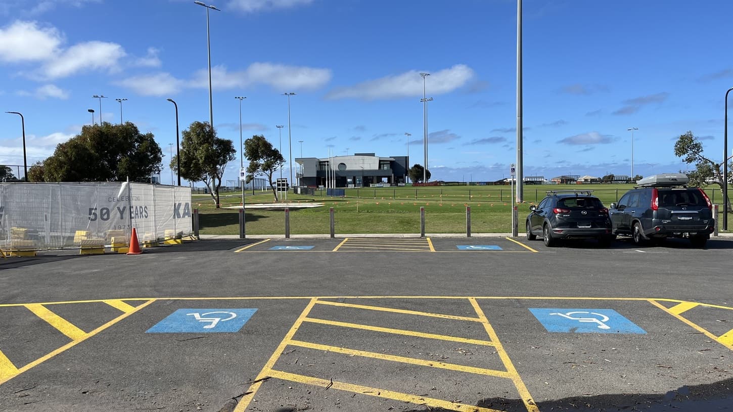 View from disabled carparks towards the oval, grant pavillion and path to access Wurdi Baierr stadium. Construction to the left, Council offices to the right. Image includes view of highjump course.