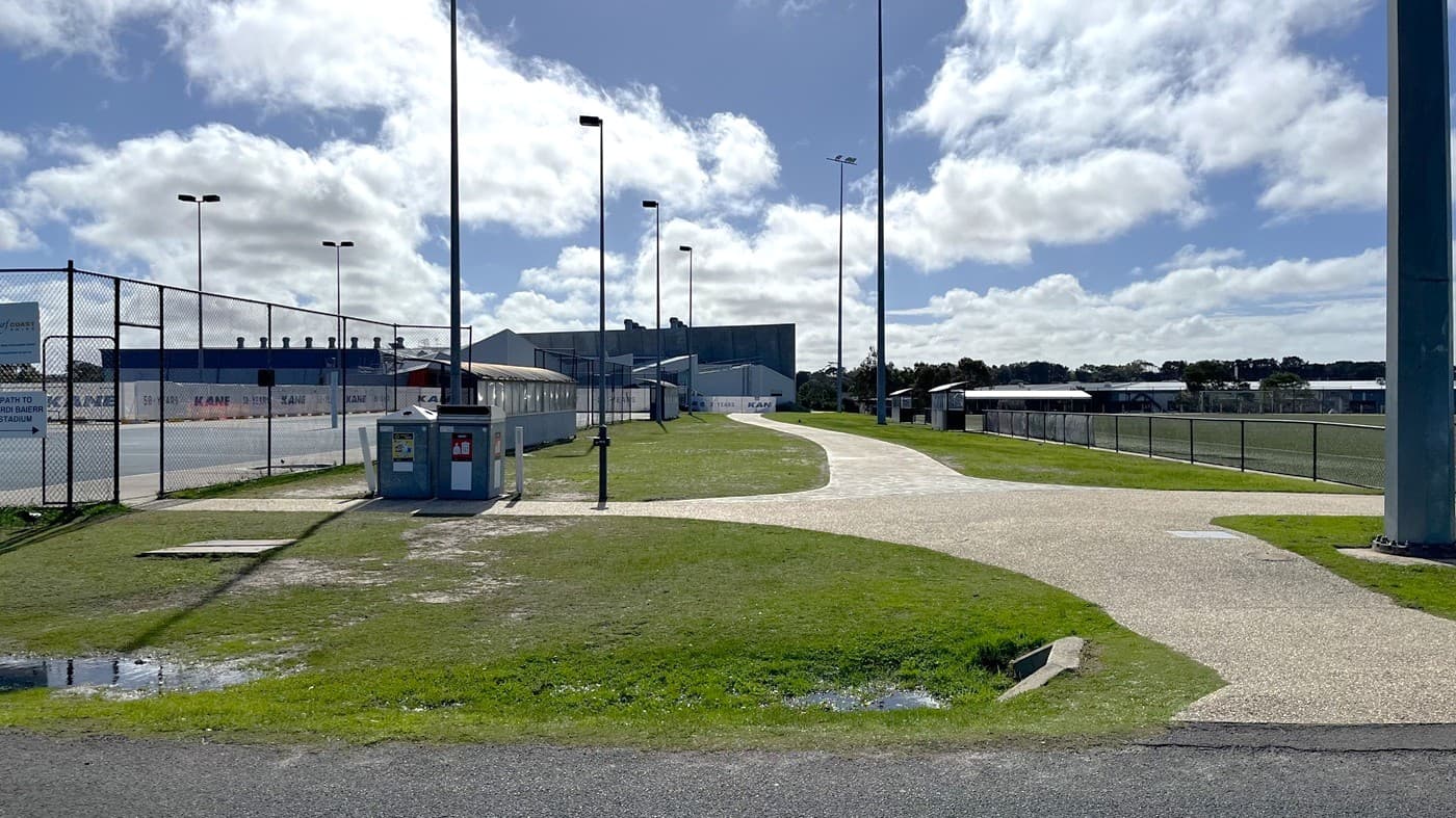 The view of the path to access Wurdi Baierr stadium after you turn left from the straight path towards Grant Pavillion. The stadium is at the end of the path. The netball courts are on the left and the soccer fields are on the right. You might hear people playing soccer on this section of path.